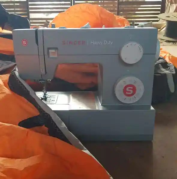 Sewing kite canopy repairs at JBay Kiteboarding Curaçao